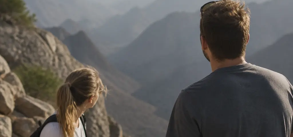 Expat Couple On A Mountain Viewpoint During A Weekend Trip From Muscat
