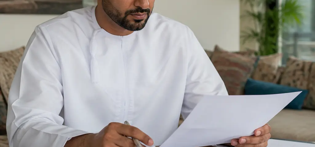 Buyer Reviewing Property Documents And Approval Requirements In Oman