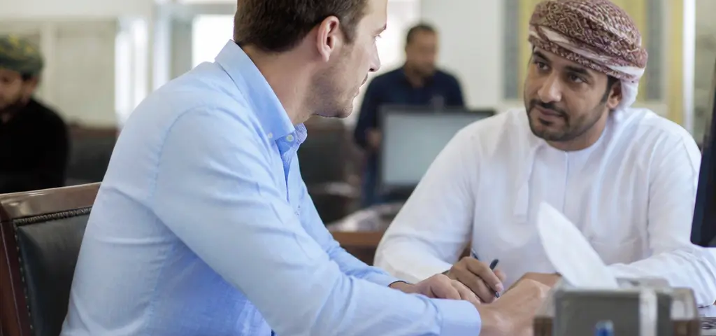 Expat Completing Residence Card Formalities At A Muscat Civil-Status Service Centre